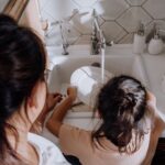 Parent guiding a child as they learn responsibility through everyday tasks