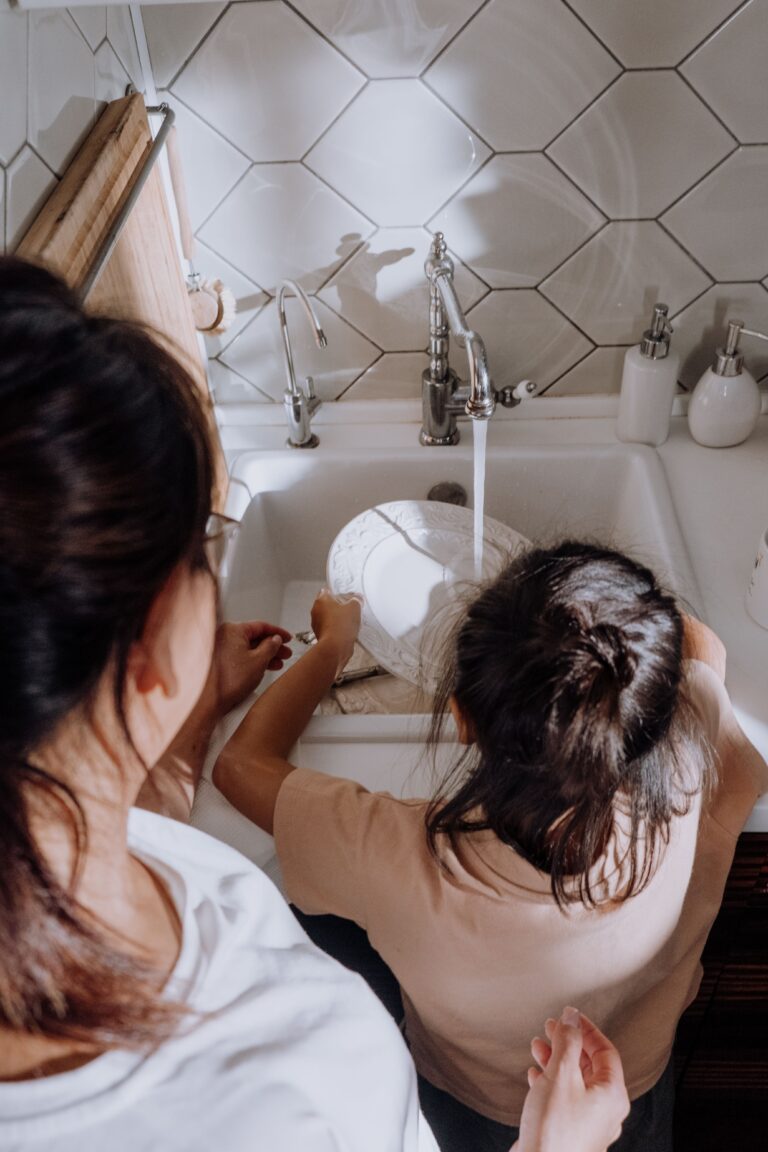 Parent guiding a child as they learn responsibility through everyday tasks